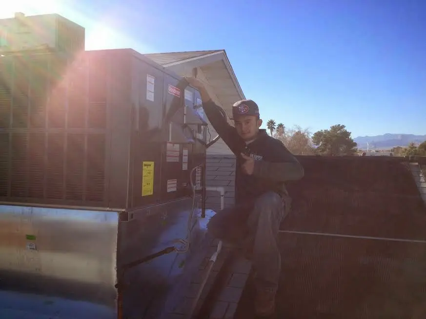 HVAC technician performing HVAC Inspection on a rooftop unit in Coal City